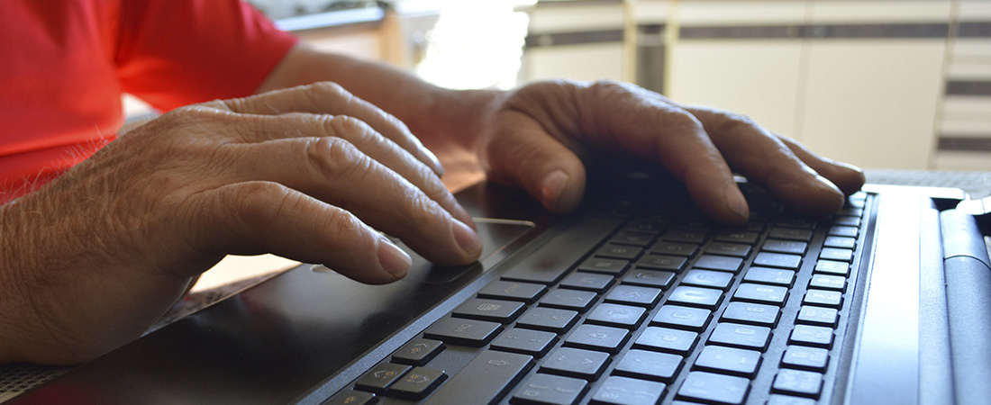 A photo of a person typing on a keyboard.