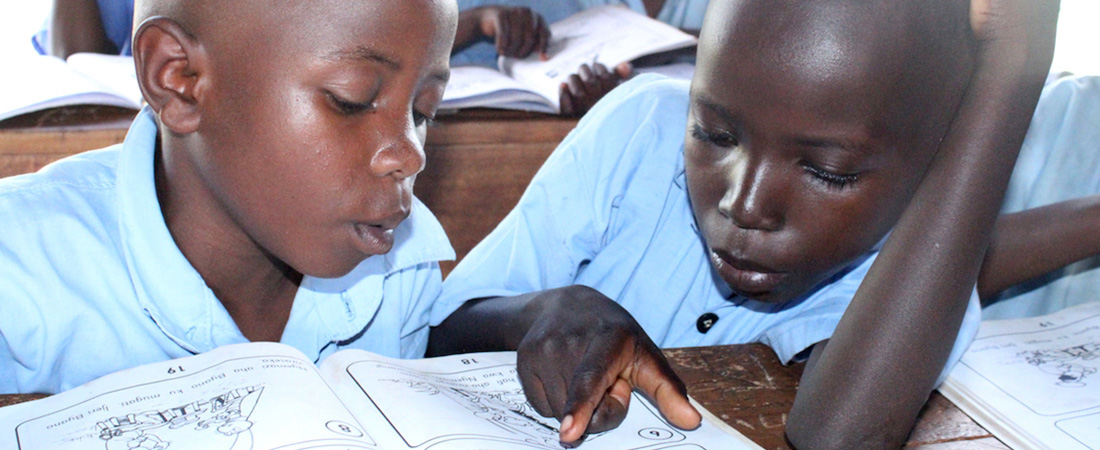 Students reading from a book.