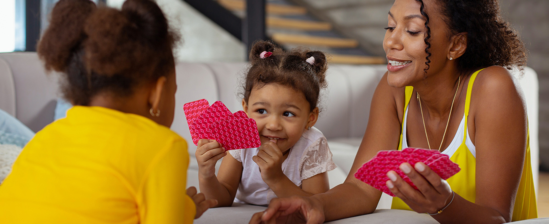 A photo of a family playing cards to represent EDC Talks: Making Time for Family Math