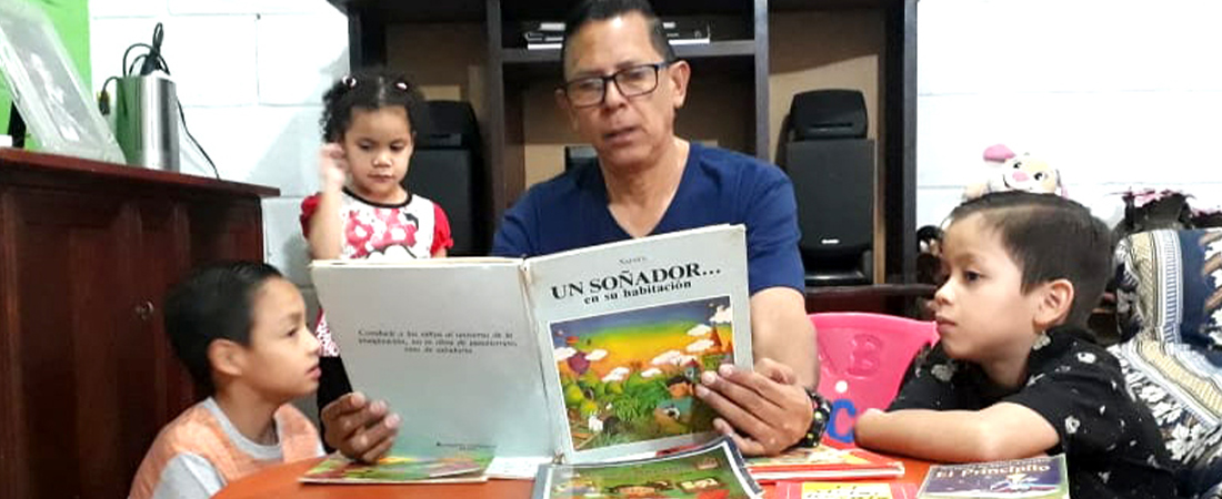 A photo of a family reading in Honduras representing With Schools Closed, Honduran Students Learn at Home