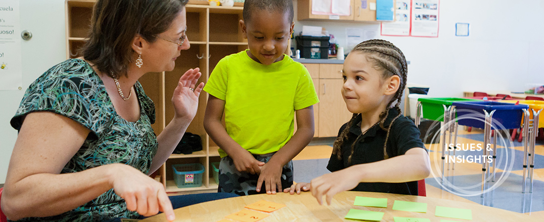 A photo of EDC's Kristen Reed playing a math game with children.