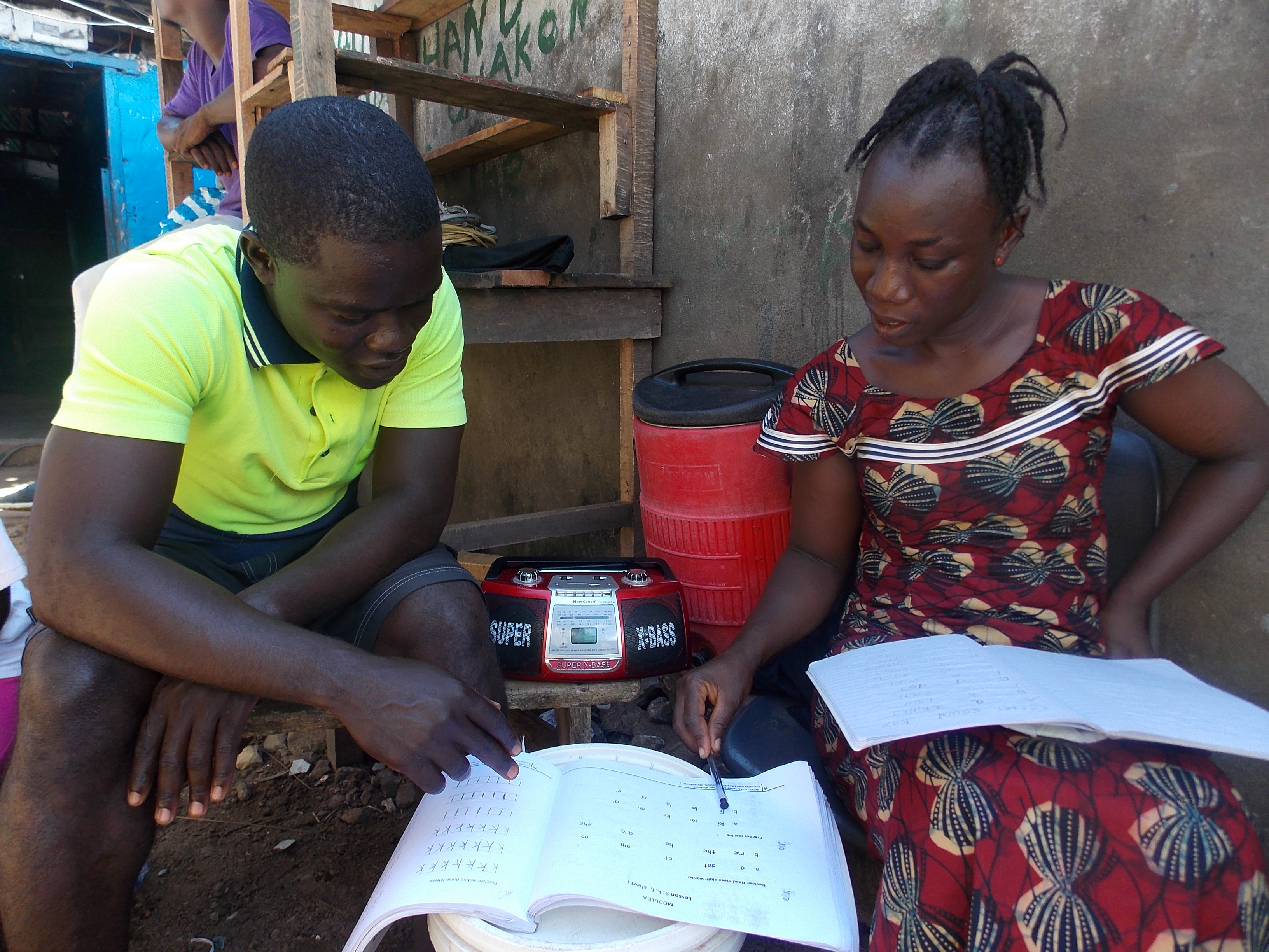 Youth listening to EDC radio program in Liberia.