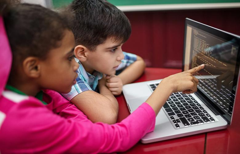 A photo of kids using a computer representing Celebrating Computer Science Education Week