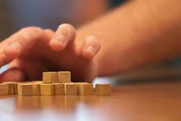 A picture of a child using blocks to solve a math problem.