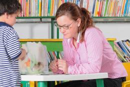 A picture of a teacher with a young student.