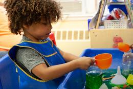 A photo of youths engaged in science activity representing "Growing an Early Interest in Science"