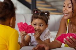 A photo of a family playing cards to represent EDC Talks: Making Time for Family Math