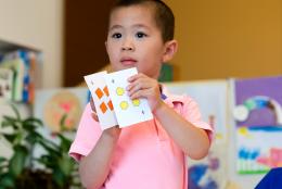 A photo of a young child doing math representing Learning Math with Your Preschoolers: Fun in the Talking and the Playing